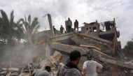 Palestinians check the rubble of a residential building destroyed in an Israeli strike in Al-Zawayda in the central Gaza Strip on May 11, 2024. (Photo by AFP)