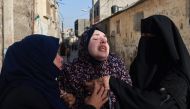 Rania Abu Anza (C) the mother of twin babies Naeem and Wissam, killed in an overnight Israeli air strike, mourns their death ahead of their burial in Rafah in the southern Gaza Strip on March 3, 2024. (Photo by MOHAMMED ABED / AFP)