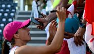 Poland's Iga Swiatek signs autographs after winning against USA's Coco Gauff at the Women's WTA Rome Open tennis tournament at Foro Italico in Rome on May 16, 2024. (Photo by Tiziana Fabi / AFP)