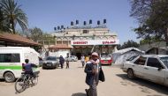 Palestinians walk outside the European hospital in Khan Yunis in the southern Gaza Strip on May 17, 2024. (Photo by AFP)