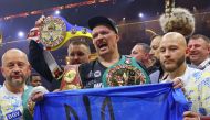 Ukraine's Oleksandr Usyk (C) celebrates his victory over Britain's Tyson Fury at Kingdom Arena in Riyadh, Saudi Arabia on May 19, 2024. (Photo by Fayez Nureldine / AFP)