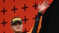 Second-placed McLaren's British driver Lando Norris waves on the podium of the Emilia Romagna Formula One Grand Prix at the Autodromo Enzo e Dino Ferrari race track in Imola on May 18, 2024. (Photo by ANDREJ ISAKOVIC / AFP)