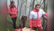 This grab taken from handout video footage released by the Iranian Red Cescent on May 20, 2024 shows rescuers recovering bodies at the site of President Ebrahim Raisi's helicopter crash in a fog-shrouded mountainous area of northwest Iran. (Photo by Iranian Red Crescent / AFP)