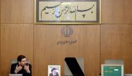 A handout picture released by the Iranian presidency shows Iran's First Vice President Mohammad Mokhber, with the seat of the late president Ebrahim Raisi (portrait) next to him empty, addressing the country's cabinet in Tehran on May 20, 2024. (Photo by Iranian Presidency / AFP) 