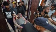 Injured Palestinians are transported to the Al-Aqsa Martyrs Hospital in Deir al-Balah following Israeli bombardment of al-Bureij in the eastern Gaza Strip on May 21, 2024. Photo by AFP