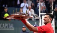 Serbia's Novak Djokovic reacts with his birthday cake after winning his ATP 250 Geneva Open tennis tournament single match against Germany's Yannick Hanfmann, in Geneva, on May 22, 2024. (Photo by Fabrice Coffrini / AFP)