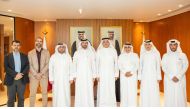 Minister of Communications and Information Technology H E Mohammed bin Ali Al Mannai pose for a group photo with other officials.