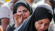 A Palestinian woman cries after identifying victims at the Al-Aqsa Martyrs Hospital in Deir al-Balah following Israeli bombardment overnight on May 23, 2024. (Photo by Bashar Taleb / AFP)