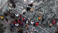 Palestinians search for survivors at the site of an Israeli strike on the Al-Daraj neighbourhood in Gaza City on May 24, 2024. (Photo by Omar Al-Qattaa / AFP)