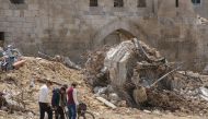 Palestinians near the ruins of destroyed buildings following the withdrawal of Israeli troops in Khan Younis, southern gaza, on April 10. MUST CREDIT: Ahmad Salem/Bloomberg
