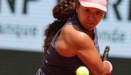 Japan's Naomi Osaka eyes the ball as she plays against Italy's Lucia Bronzetti during their women's singles match on day one of The French Open tennis tournament on Court Philippe-Chatrier at The Roland Garros Complex in Paris on May 26, 2024. (Photo by Alain JOCARD / AFP)