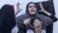 Palestinians react after an Israeli strike on a building in Nuseirat on May 25, 2024. (Photo by Bashar Taleb / AFP)