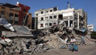 A Palestinian man walks past a destroyed building in Rafah in the southern GAZA Strip on May 26, 2024. (Photo by Eyad BABA / AFP)
