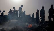 Palestinians gather at the site of an Israeli strike on a camp for internally displaced people in Rafah on May 27, 2024. (Photo by Eyad Baba / AFP)

