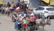 Palestinians fleeing unsafe areas in Rafah arrive with their belongings on a donkey-cart in Khan Yunis. (Photo by Bashar Taleb / AFP)