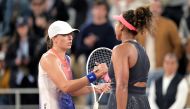 Poland's Iga Swiatek (left) shakes hands with Japan's Naomi Osaka after winning their women's singles match on Court Philippe-Chatrier on day four of the French Open tennis tournament at the Roland Garros Complex in Paris on May 29, 2024. (Photo by Bertrand Guay / AFP)