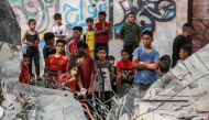 Palestinian children stand next to the rubble of the Zaqout family' house hit during overnight Israeli bombardment in Nuseirat, in the central Gaza Strip, on May 30, 2024. (Photo by Bashar Taleb / AFP)