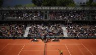 US Brandon Nakashima plays an overhead smash on Court Simonne-Mathieu on day five of the French Open tennis tournament at the Roland Garros Complex in Paris on May 30, 2024. (Photo by Anne-Christine Poujoulat / AFP)
 