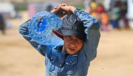 A Palestinian boy carries a water container in Rafah, in the southern GAZA Strip, on May 31, 2024. (Photo by Eyad BABA / AFP)
