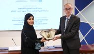 Director of Aljazeera Media Institute Eman Al Amri and Dean of the College of Computing and Information Technology at UDST Zakaria Maamar exchanging documents after signing an agreement.