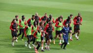 Belgium's players and physical coach Vladimir Cepzanovic (in blue) warm up during a training session as part of the team's preparation for the Euro 2024 European football championships at the Royal Belgian Football Association's training center in Tubize, on June 4, 2024. (Photo by Virginie Lefour / Belga / AFP) 
 