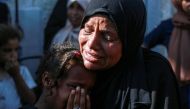 A Palestinian woman and a child cry as they mourn the death of a loved ones following Israeli bombardment, outside a hospital in Deir el-Balah in the central Gaza Strip, on June 7, 2024. (Photo by Bashar Taleb / AFP)
