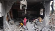 Palestinians children search through the rubble of their home a day after an operation by the Israeli Special Forces in the Nuseirat camp, in the central Gaza Strip on June 9, 2024.(Photo by Eyad Baba / AFP)