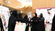 Minister of Education and Higher Education H E  Buthaina bint Ali Al Jabr Al Nuaimi with officials and the graduates during the graduation ceremony.