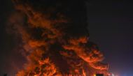 Flames rise after a massive fire broke out at the asphalt storage facility of an oil refinery in Arbil on Jun 13, 2024. (Photo by Safin Hamid / AFP)