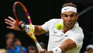 File:  Spain's Rafael Nadal returns the ball to Italy's Lorenzo Sonego during their men's singles tennis match on the sixth day of the 2022 Wimbledon Championships at The All England Tennis Club in Wimbledon, southwest London, on July 2, 2022.(Photo by SEBASTIEN BOZON / AFP)