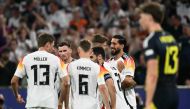 Germany's midfielder #25 Emre Can (R) celebrates with teammates after scoring his team's fifth goal during the UEFA Euro 2024 Group A football match between Germany and Scotland at the Munich Football Arena in Munich on June 14, 2024. Photo by Fabrice COFFRINI / AFP.