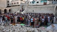 Palestinians perform the Eid al-Adha morning prayer in the courtyard of Gaza City's historic Omari Mosque on June 16, 2024. (Photo by Omar Al Qattaa / AFP)