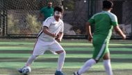 Members of Iraq's first national football team for the visually impaired, train at a sports club in Baghdad on May 22, 2024. (Photo by Ahmad Al-Rubaye / AFP)