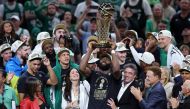 Jaylen Brown of the Boston Celtics holds up the Larry O'Brien trophy after Boston's 106-88 win against the Dallas Mavericks in Game Five of the 2024 NBA Finals at TD Garden on June 17, 2024 in Boston, Massachusetts.(Photo by Adam Glanzman / GETTY IMAGES NORTH AMERICA / Getty Images via AFP)