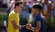 Britain's Jack Draper is congratulated by Spain's Carlos Alcaraz (R) at the end of their men's singles round of 16 match at the Cinch ATP tennis Championships at Queen's Club in west London on June 20, 2024. (Photo by HENRY NICHOLLS / AFP)