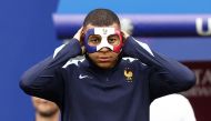 France's forward #10 Kylian Mbappe wears a face mask as he takes part in a MD-1 training session at the Leipzig Stadium in Leipzig on June 20, 2024, on the eve of their UEFA Euro 2024 Group D football match against Netherlands. (Photo by Franck Fife / AFP)