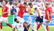 England's midfielder #10 Jude Bellingham reacts after being tackled by Denmark's midfielder #10 Christian Eriksen (right) during the UEFA Euro 2024 Group C football match between Denmark and England at the Frankfurt Arena in Frankfurt am Main on June 20, 2024. (Photo by Kirill Kudryavtsev / AFP)
 