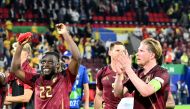 Belgium's forward #22 Jeremy Doku (L) and Belgium's midfielder #07 Kevin De Bruyne celebrate after winning the UEFA Euro 2024 Group E football match between Belgium and Romania at the Cologne Stadium in Cologne on June 22, 2024. (Photo by Alberto PIZZOLI / AFP)
