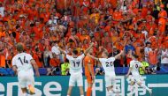 Austria's midfielder #09 Marcel Sabitzer (right) celebrates scoring his team's third goal with his teammates during the UEFA Euro 2024 Group D football match between the Netherlands and Austria at the Olympiastadion in Berlin on June 25, 2024. (Photo by Odd Andersen / AFP)