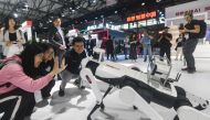 Visitors interact with a Lenovo robot at the Mobile World Congress (MWC) in Shanghai on June 26, 2024. (Photo by AFP)
 