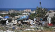 People look for salvageable items following an Israeli raid on June 29, 2024. (Photo by Eyad Baba / AFP)