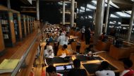 A picture taken on June 28, 2024 in the Mediterranean city of Alexandria, shows Egyptian high school students keeping cool by studying in the Alexandria Library, as Egypt began implementing planned power cuts. (Photo by Hazem Gouda / AFP)