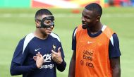 France's forward #10 Kylian Mbappe (L) jokes with France's forward #15 Marcus Thuram during a training session at the Home Deluxe Arena Stadium in Paderborn, western Germany, on June 27, 2024, during the UEFA EURO 2024 football competition. Photo by FRANCK FIFE / AFP