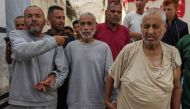 Palestinian men who had been detained by Israeli forces arrive after their release for a check-up at the Al-Aqsa Martyrs Hospital in Deir al-Balah on July 1, 2024. (Photo by Bashar Taleb / AFP)