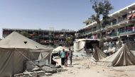 Palestinians stand near damaged tents after an Israeli strike in Khan Yunis in the southern Gaza Strip on July 4, 2024. (Photo by Bashar Taleb / AFP)