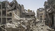  Palestinians check residential buildings destroyed by Israeli warplanes in Gaza City, July 4, 2024.(Photo by Mahmoud Zaki/Xinhua)