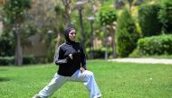 Palestinian Karate-ka Mais Elbostami trains in a park near her home, east of the Egyptian capital Cairo on June 25, 2024. (Photo by Khaled Desouki / AFP)