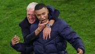 France's head coach Didier Deschamps and France's forward #10 Kylian Mbappe celebrate after winning the UEFA Euro 2024 quarter-final football match between Portugal and France at the Volksparkstadion in Hamburg on July 5, 2024. (Photo by Ronny Hartmann / AFP)