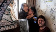 Children react after Israeli bombardment as they take refuge at the Jaouni school run by the UN Relief and Works Agency for Palestine Refugees (UNRWA) in Nuseirat in the central Gaza Strip on July 6, 2024. (Photo by Eyad Baba / AFP)