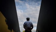 A security guard stands guard at the entrance of Court 12 on the seventh day of the 2024 wimbledon Championships at The All England Lawn Tennis and Croquet Club in Wimbledon, southwest London, on July 7, 2024. (Photo by Andrej Isakovic / AFP) 